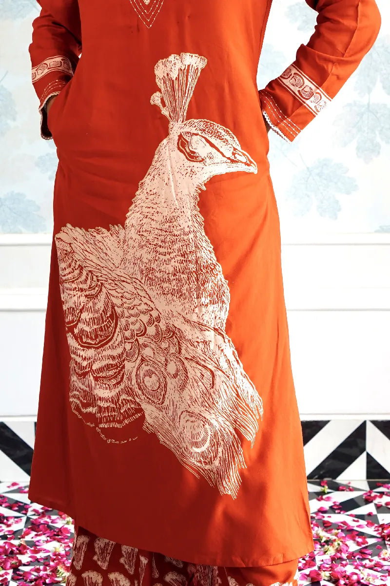 RUST ORANGE KURTA SET WITH HAND-PRINTED WHITE PEACOCK MOTIF & CONTRAST DETAILING