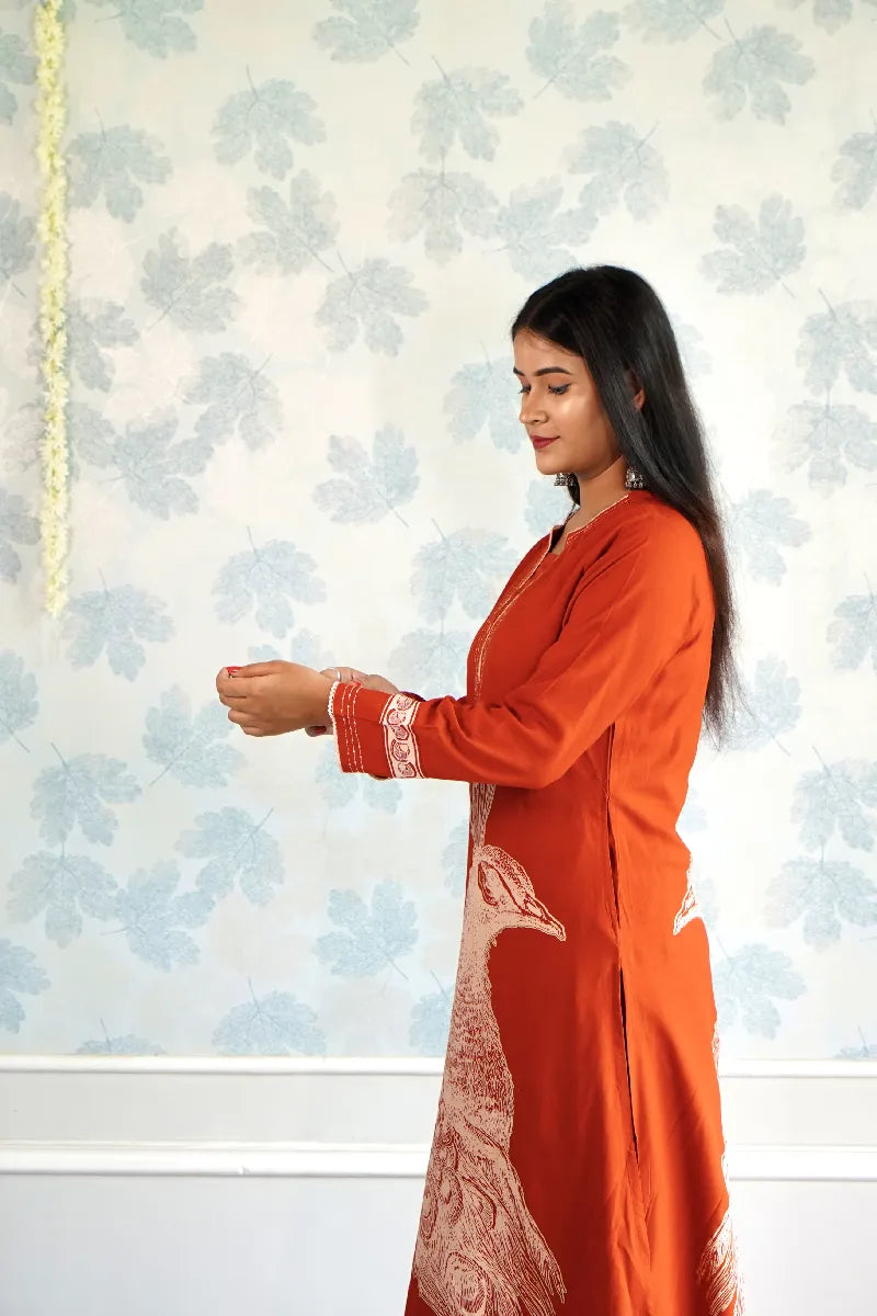 RUST ORANGE KURTA SET WITH HAND-PRINTED WHITE PEACOCK MOTIF & CONTRAST DETAILING