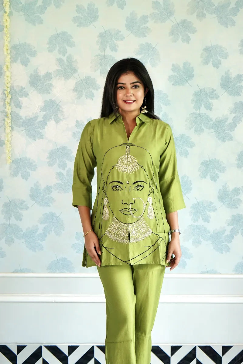 OLIVE GREEN KURTA SET WITH EMBROIDERED WOMAN FACE ART & STATEMENT JEWELRY DETAILING