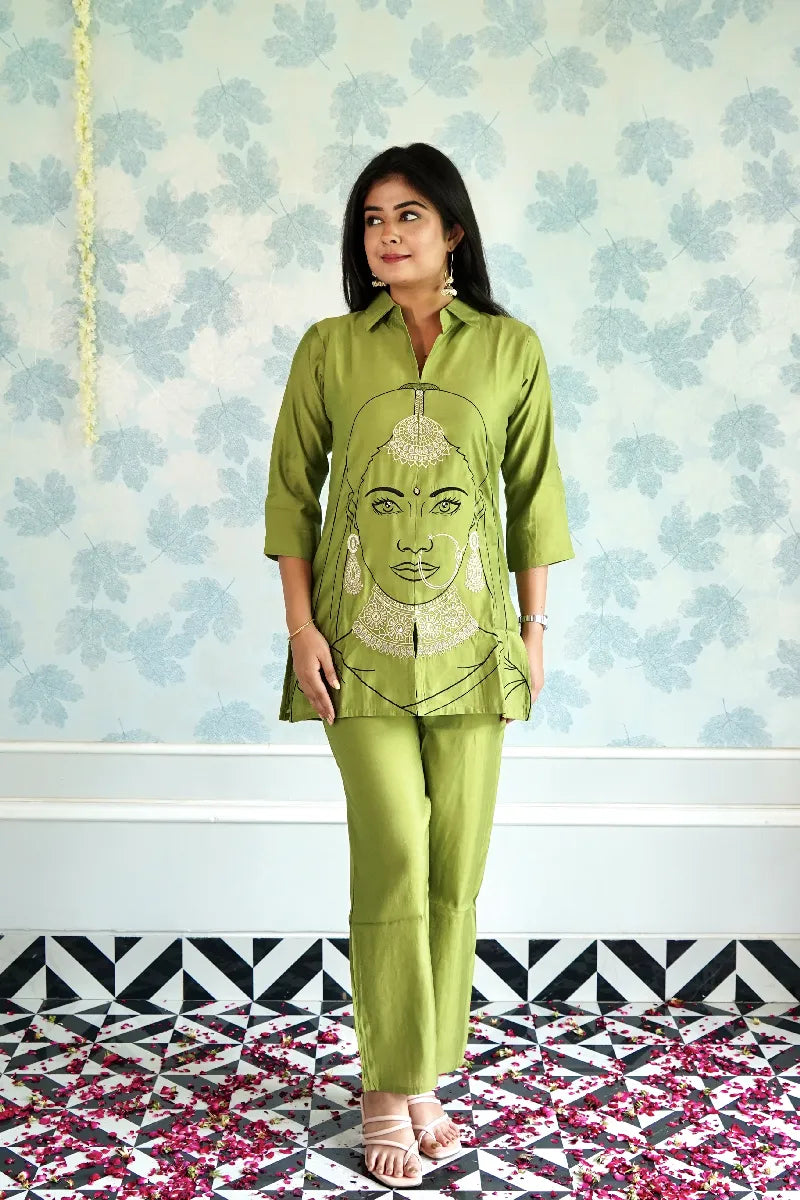 OLIVE GREEN KURTA SET WITH EMBROIDERED WOMAN FACE ART & STATEMENT JEWELRY DETAILING
