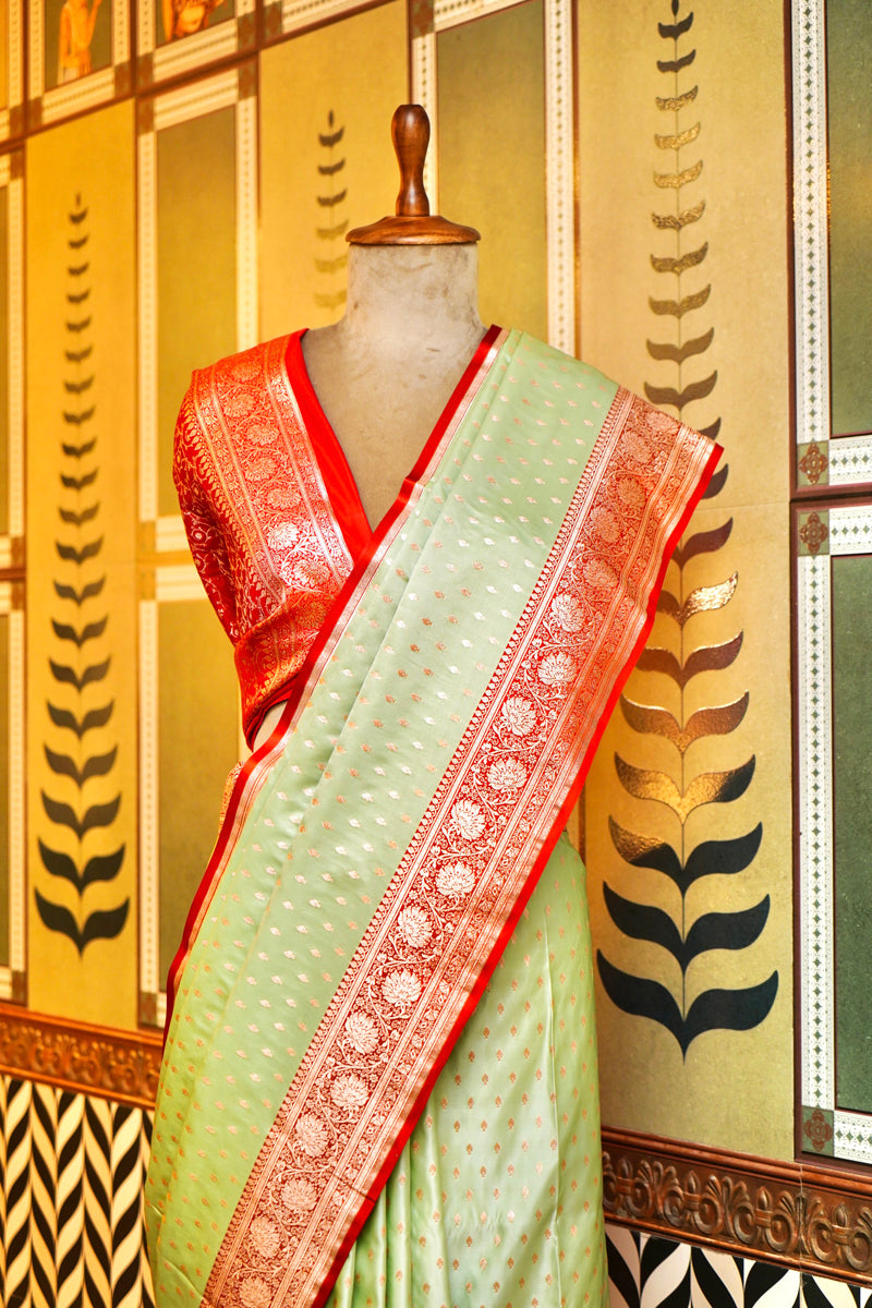 PESTLE PISTA GREEN WITH GOLDEN ZARI BOOTI WORK WITH RED BORDER